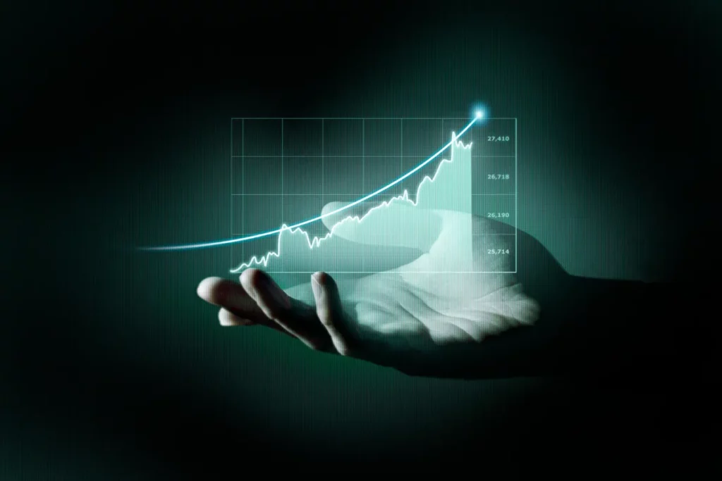 Mão segurando um gráfico de crescimento financeiro em ascensão, simbolizando sucesso ao descobrir qual é a melhor forma de investir dinheiro